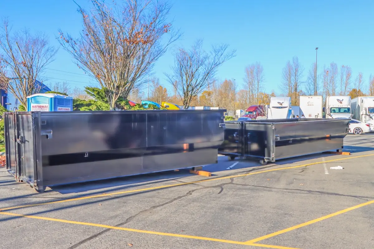Professional dumpster rental service with roll-off container on residential driveway in Indian Wells